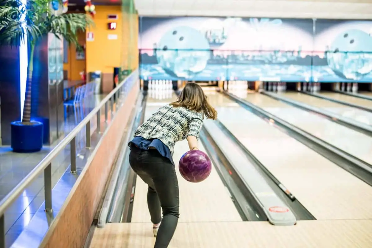 Young pretty girl having fun and enjoying herself while bowling - Is Bowling a Sport